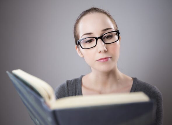 Woman taking an IELTS reading practice test.
