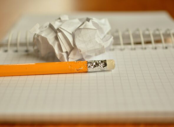 The picture shows a crumpled up piece of paper implying that it's not easy to write successfully for IELTS