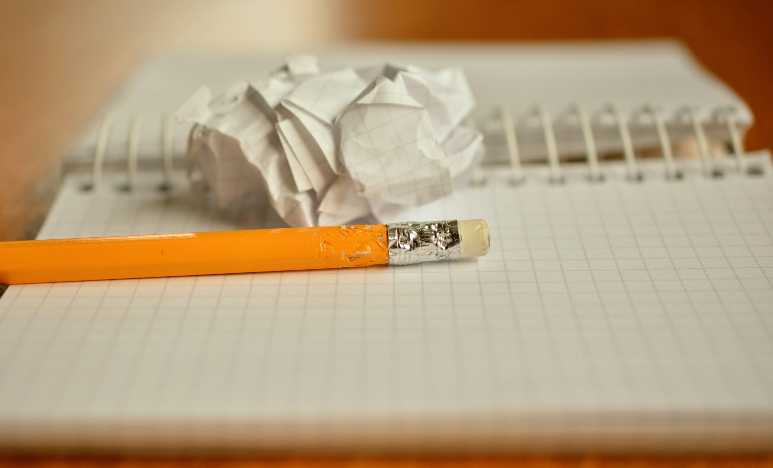 The picture shows a crumpled up piece of paper implying that it's not easy to write successfully for IELTS